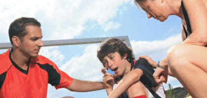 A picture of a boy playing sports who have an asthma crisis.