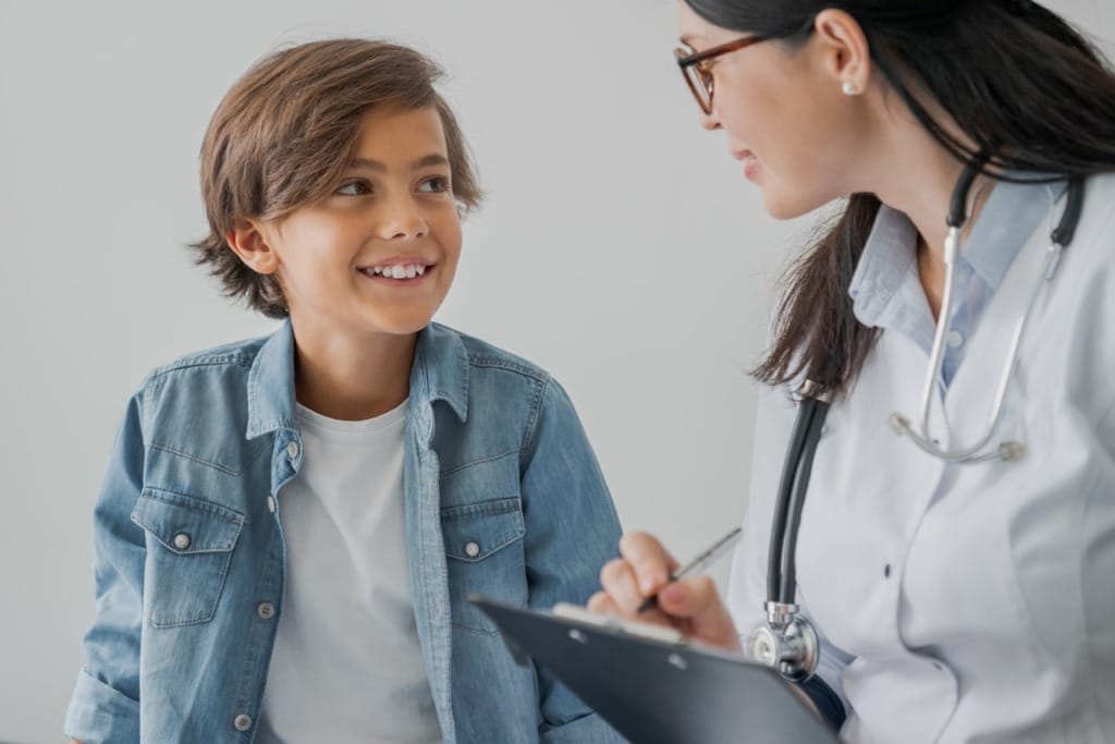 Child reviewing allergy action plan with healthcare provider