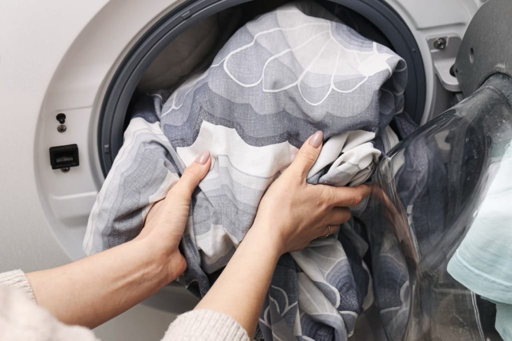 Washing bedding to remove dust mites and pollen